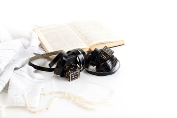 Tallit and tefillin and Tora (book) on white background