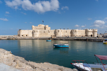 Citadel of the city of Alexandria, seen from the part of the sea full of ships, on a sunny day.