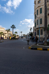 Streets of the city of Alexandria, with people walking around, on a sunny day.