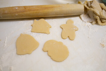 Fototapeta na wymiar Rolling out sugar cookies on a cutting board