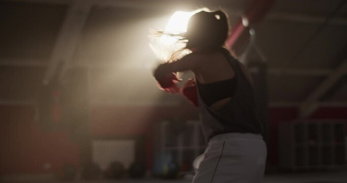 Sportswoman shadow boxing under sunlight