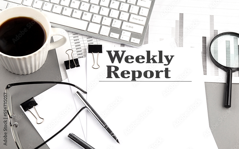 Poster weekly report text on a paper with magnifier, coffee and keyboard on grey background