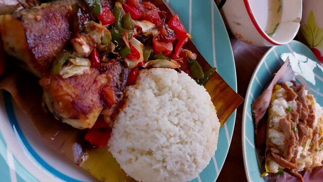 Vertical video showcasing Khmer breakfast dishes, rice with pork or Bai Sach Chrouk and fried fish in spicy sauce or Trei boeng kanh chhet