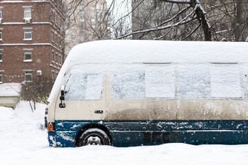 bus covered with snow after a snowfall