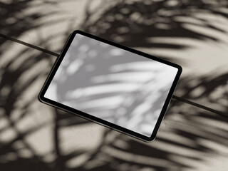 tablet with white screen to put text with shadow of palm tree leaves