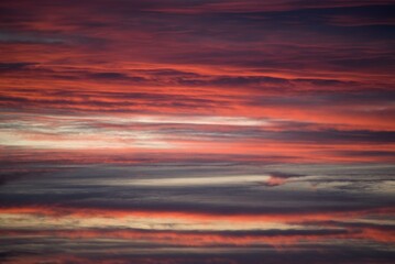 Beautiful evening sky with orange, grey, yellow clouds after the sunset, like an abstract painting