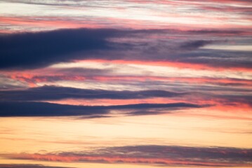 Beautiful evening sky with orange, grey, yellow clouds after the sunset, like an abstract painting