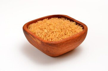 bowl with uncooked chinese bronze rice isolated on white background