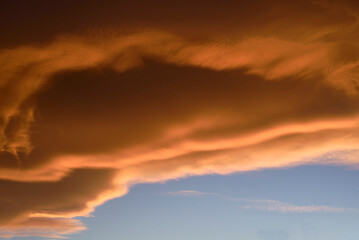 Sky light after sunset. orange background. Clouds.