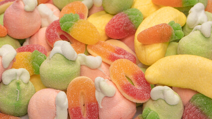 Mix of jelly candys and marshmallows isolated on a white background.