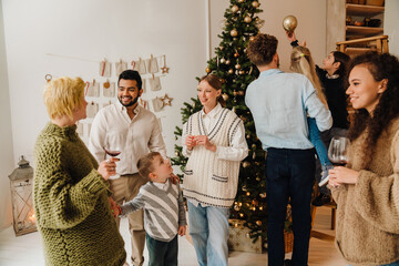 Cheerful family spending time together during Christmas holidays near Christmas tree
