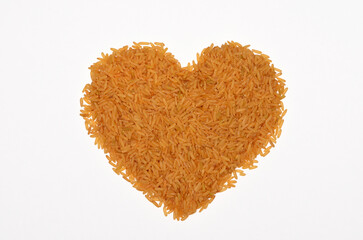 heart shaped pile of bronze rice isolated on white background
