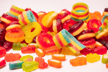 Assorted colorful gummy candies. Top view. Jelly donuts. Jelly bears. Isolated on a white background.