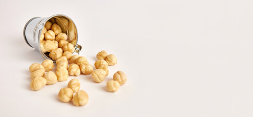 A metal bucket with scattered nuts. Nuts are a useful and nutritious product.