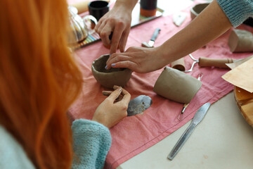 Pottery workshop class. A pottery crafts dish from a raw clay. Creating ceramics