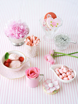 Tea Cups and Dishes Full of Sweets and Flowers