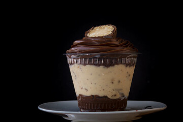 Mousse and pot cake, chocolate, strawberry and other creams, sugared strawberry, with chocolate bonbon, spoon, fabric, rustic wood