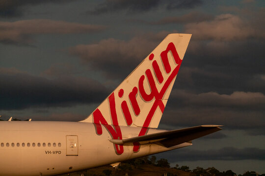 VIRGIN AUSTRALIA Tail Of A Plane With Dark, Cloudy, Moody, Stormy Background. 