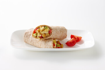 Breakfast Wrap made with Whole Wheat Tortilla filled with Egg, Chickpeas, Red Peppers and Avocado, Studio Shot