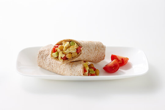 Breakfast Wrap Made With Whole Wheat Tortilla Filled With Egg, Chickpeas, Red Peppers And Avocado, Studio Shot