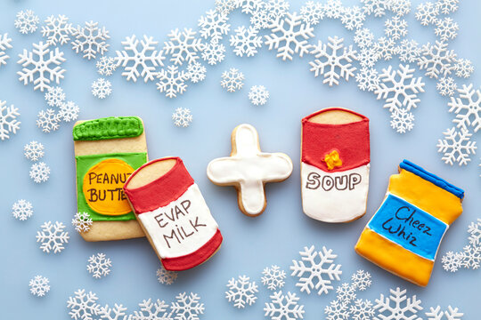 Overhead View of Sugar Cookies Decorated like Food Products on Blue Background with Snowflakes