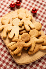 Cooking gingerbread man cookies. Baked cookie blanks just from the stove. Vertical photography.
