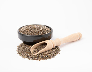 Chia seeds in a plate with a wooden spoon isolated on a white background. Superfood. Healthy food. Diet. Antioxidant. Place for text. Place to copy.
