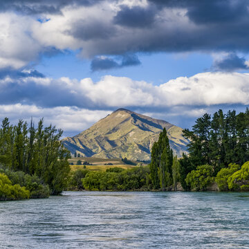 Mount Maude and river scenic on a sunny day with a cloudy sky near Albert Town; Otago Region, Southland, New Zealand