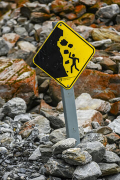 Cautionary sign placed on rocky trail to beware of falling rocks along the Franz Josef Glacier Walk in Westland Tai Poutini National Park; Whataroa, West Coast Region, South Island, New Zealand