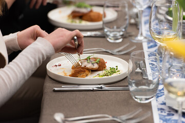 woman is going to eat a herring with potato Kroket croquette Dutchs favourite snack deep-fried ragout filled snack in a restaurant