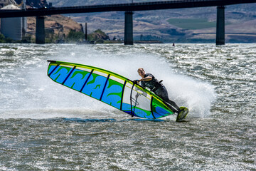 Windsurfer cutting a turn on waves of the Columbia River near Maryhill, Washington, USA