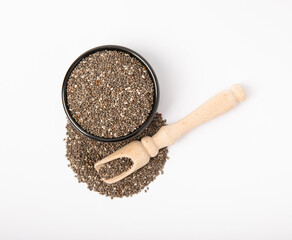 Chia seeds in a plate with a wooden spoon isolated on a white background. Superfood. Healthy food. Diet. Antioxidant. Place for text. Place to copy.