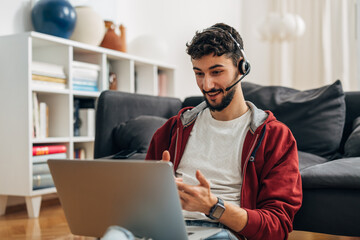 Businessman is having an enjoyable online meeting at home