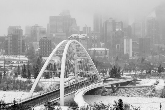 Walterdale Bridge crossing the frozen North Saskatchewan River in the city of Edmonton in winter; Edmonton, Alberta, Canada