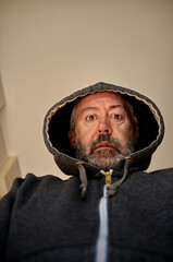 worried middle aged, in hooded jacket