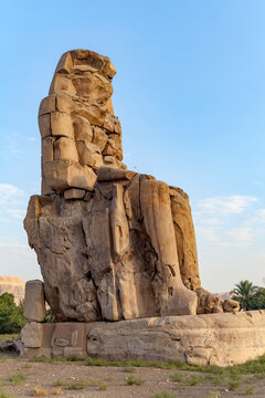 Colossi of Memnon, one of the two ancient stone statues of Pharaoh Amenhotep III who ruled during the 18th Dynasty at Theban Necropolis, west of the River Nile; Luxor, Egypt