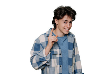 Teenager boy wearing blue plaid shirt over transparent background rises index finger, pensive expression. Smiling with cheerful face. Idea concept. Clever teen isolated on transparent studio backdrop.