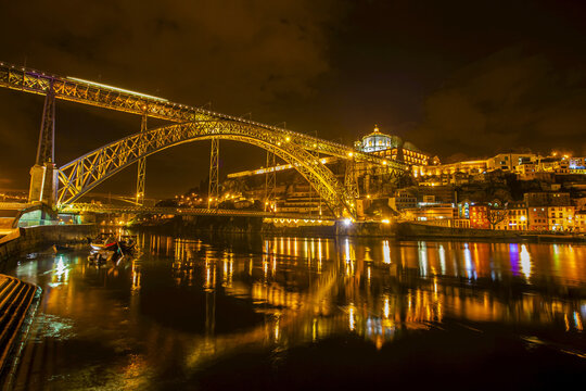 Dom Luis I Bridge crossing River Douro with Vila Nova de Gaia lit up at night, Porto, Portugal