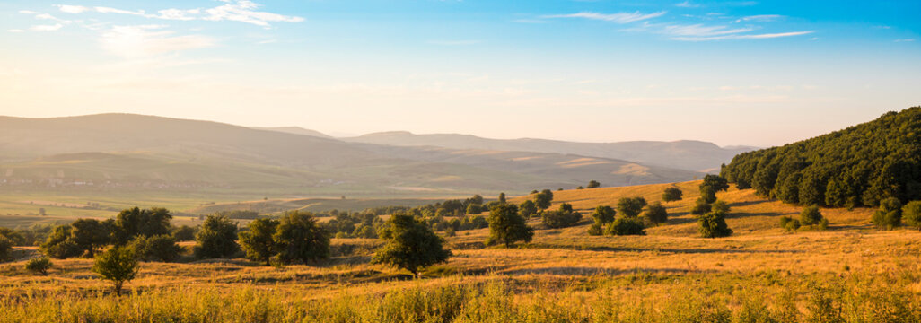 Sunset rural landscape with fields, meadows and forest, Cata, near Rupea, Brasov County; Cata, Transylvania, Romania