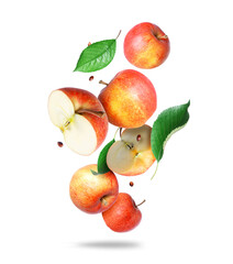 Whole and sliced ​​ripe apples with green leaves in the air closeup on a white background