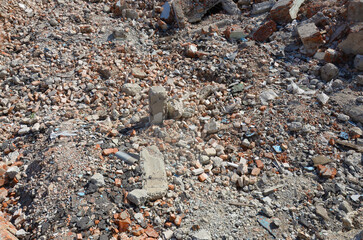 Pile of broken red bricks and fragments of concrete from destroyed building. Broken bricks close up...