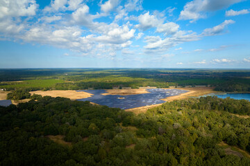 Obraz premium Aerial view of big sustainable electric power plant with many rows of solar photovoltaic panels for producing clean electrical energy. Renewable electricity with zero emission concept