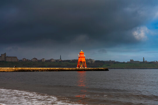 Herd Groyne Lighthouse under storm clouds; South Shields, Tyne and Wear, England