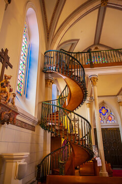 Interior of the historic Loretto Chapel with its spiraling, Miraculous Staircase; Santa Fe, New Mexico, United States of America