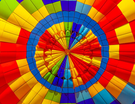 The fabric of a hot-air balloon in vibrant colours and vent at the top; Arizona, United States of America