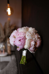 The bride's bouquet of pink peonies on dark backround.