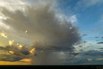 Cumulonimbus clouds forming before thunderstorm on evening sky. Changing stormy cloudscape weather...