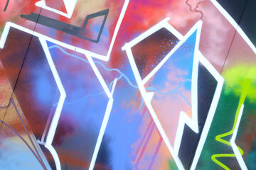 Colorful background of graffiti painting artwork with bright aerosol strips on metal wall. Old...