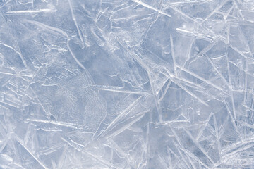 Obraz premium Abstract textured white ice cracked background. Thin ice on river surface. Copy space for your text and decorations. Beauty in winter nature theme.
