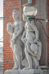 Old statues of sensual Renaissance era beautiful women after bathing at a city park and garden of...